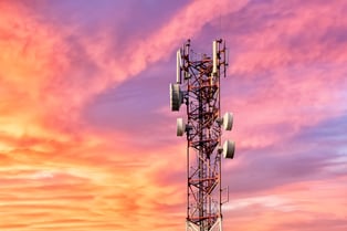 cellular network tower against a sunset 